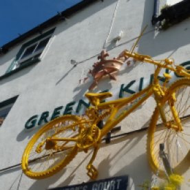 Yellow bikes: suspended from a pub...