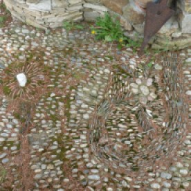 Traditional pebble paving in front of a village house.