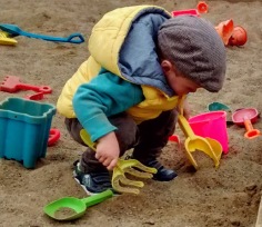 William, while he was still a toddler, plays with his bucket and spade.